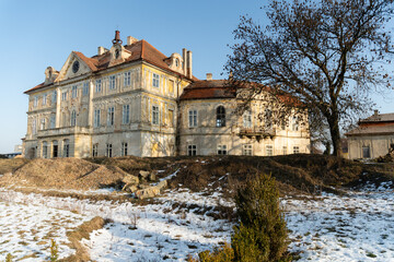 Obraz premium Bezno Chateau, a late Baroque manor near Mladá Boleslav, showing its deteriorating plasterwork and abandoned state in winter, Bezno, Czech Republic