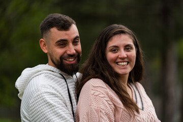 Obraz premium Cheerful young couple smiling, laughing together outdoors