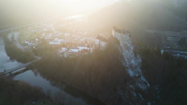 Aerial view Orava Castle above the river in sunset light. landscape, 4K, ProRes