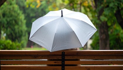 White Umbrella on Wooden Railing in Rainy Weather.
