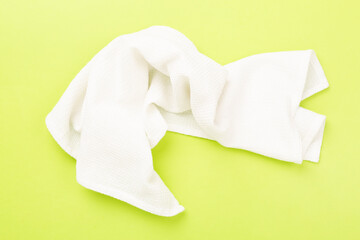 Naklejka premium Kitchen napkin on color background, top view