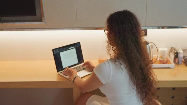 Woman diligently working in contemporary environment. Female professional concentrating on tasks in cozy office setting. Woman dedicatedly engaged in her work within modern workspace ambiance