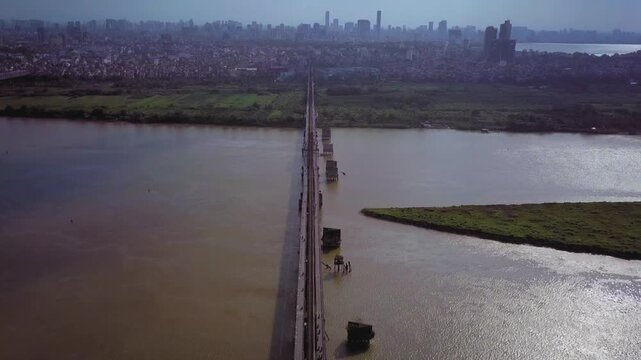 Aerial view of the historic long bien bridge crossing the red river towards hanoi's cityscape