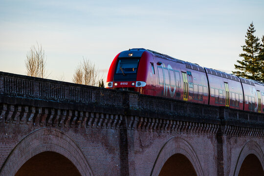 Occitanie regional TER train crossing the railway bridge over the Tarn in Albi towards Albi-Ville station