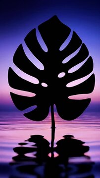 Dramatic silhouette of a Monstera leaf against a vibrant tropical sunset sky reflected in calm water a modern botanical design element for branding and marketing