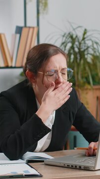 Bored sleepy Caucasian business woman worker working on laptop computer yawning leaning on hand falling asleep at office. Exhausted tired freelancer workaholic lady. Employment, occupation, workless