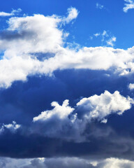 photo of dramatic cumulonimbus clouds w/vibrant blue sky behind & storm below-background, backdrop, border, wallpaper, sky, cloud, clouds, blue, weather, cloudscape, cloudy, cumulus, fluffy, beautiful