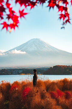 Traveler enjoying peaceful view of Mount Fuji in fall season
