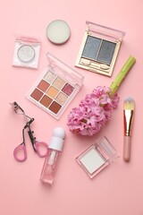 Fototapeta premium Spring composition with different makeup products and hyacinth flowers on pink background, flat lay