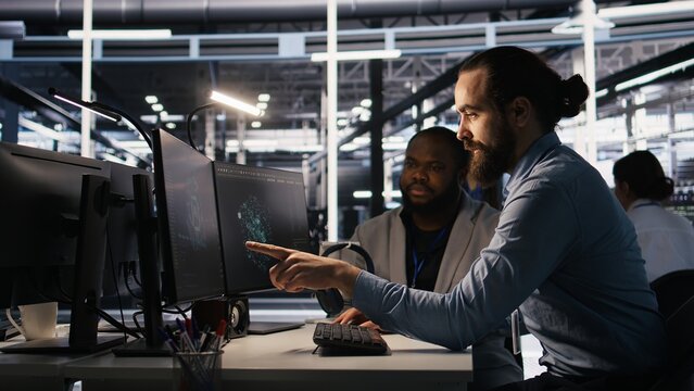 Lead data center engineer oversees team integrating AI automation tools during infrastructure maintenance. Worker under manager supervision uses machine learning models for operational tasks, camera A