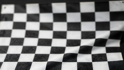 Checkered flag waves with dynamic motion on black background for racing or victory concepts
