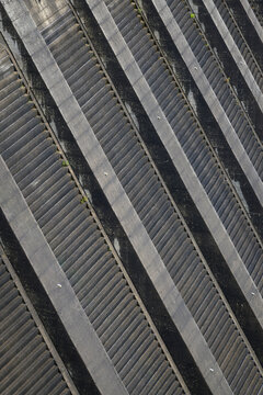 Rugged face of dam wall in closeup with overflow channel in man made structure