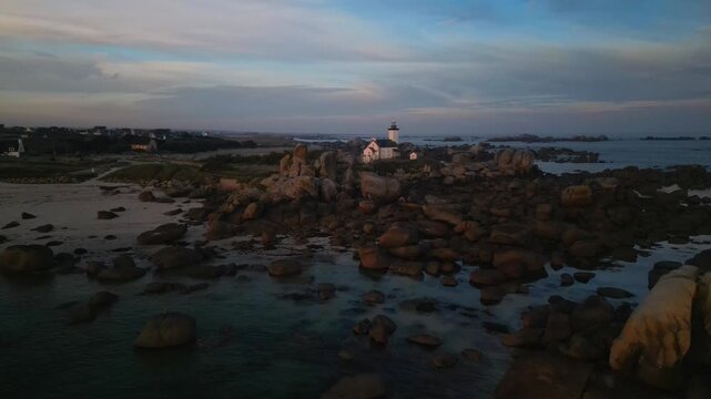 The Pontusval lighthouse, located on a rocky point in northern Finistere in Brittany, aerial footage at sunrise