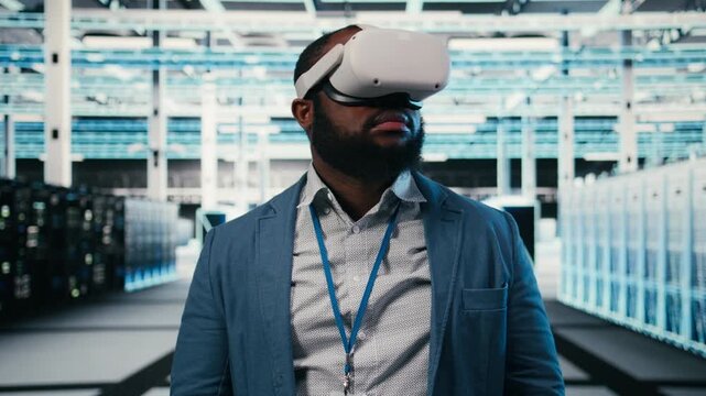 Portrait of smiling man in data center putting VR headset on to optimize electronics. Cheerful server hub system administrator using virtual reality simulation to monitor system performance, camera A