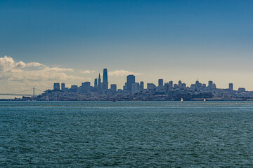 Obraz premium View of San Francisco skyline from across the water from Sausalito with clouds and blue sky above during daylight hours