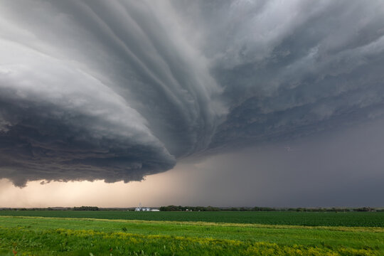 Storm clouds approaching a farm field