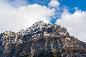 Fototapeta premium Wetterhorn peak rugged vertical rock face with snow in alpine landscape. Grindelwald, Canton of Bern, Switzerland.