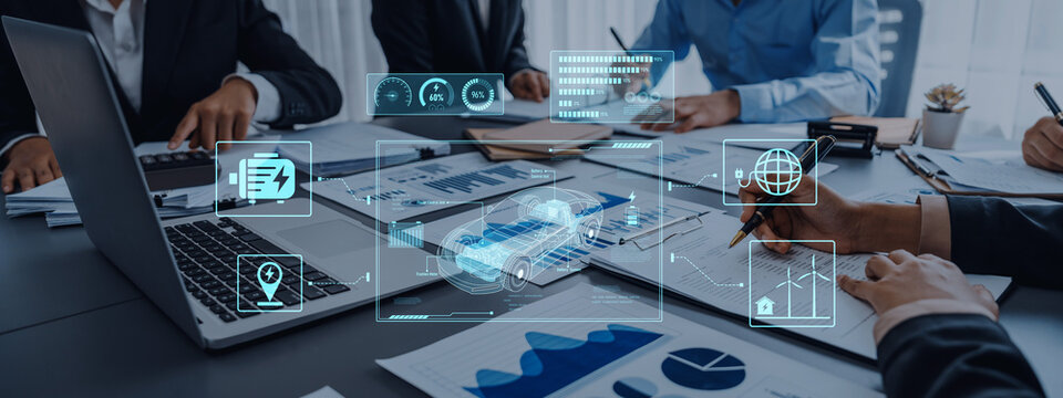 A professional business meeting focusing on data analysis, featuring digital graphs and financial reports. Team members engage in discussion with technology. Trope