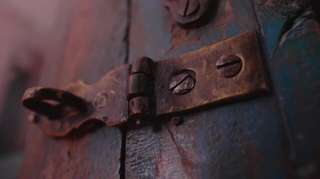 Rusty Metal Hinge and Screws on Weathered Painted Wooden Surface Highlighting Vintage Hardware Detail and Aged Industrial Texture