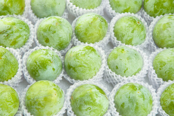 Obraz premium Fresh Green Fruits from Fujian Gutian in Protective Packaging - Premium Quality Asian Produce