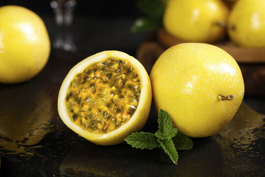 Fresh Golden Passion Fruit from Guangxi China with Honey-Colored Pulp and Mint Garnish