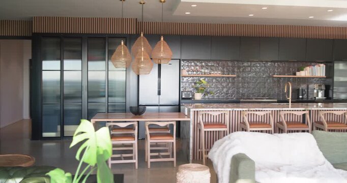 Camera is panning right, triggered by slider, revealing open-plan living kitchen and sunlight