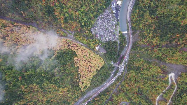Drone view of Yangrong Hade, or Yangrong Village, well-preserved Jiarong Tibetan village in Aba, Sichuan, China. Colorful autumn forest in rainy day. 4k real time footage b roll shot travel concept
