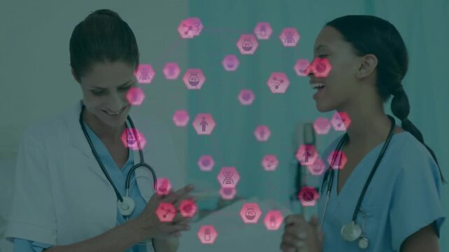 Two clinicians starting update with hand gestures in clinic, stethoscopes, pink hex icons floating