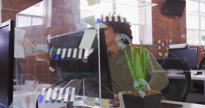 Male worker receiving offscreen sheet, reviewing office work while UI on plexiglass, typing