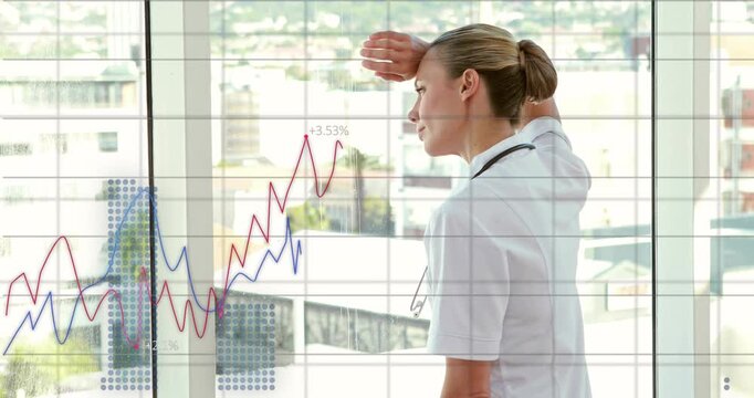 Medical worker raising hand at window with steth while animated charts emerging and tracking health