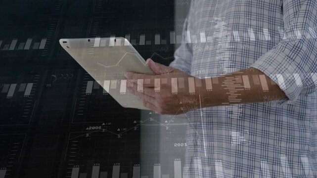 Male analyst raising tablet to scan, tapping to review analytics while charts overlay tablet