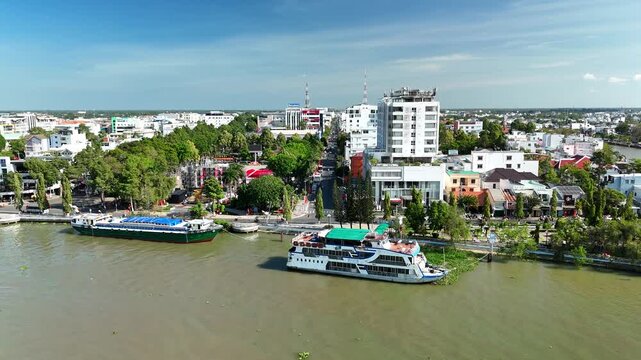 Vinh Long City, Vietnam &ndash; 4K aerial drone footage of Mekong Delta riverfront cityscape, towers, dense houses, bridges, boats and canals in southern Vietnam