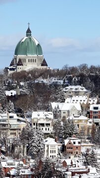 Saint Josephs Oratory dome above snowy Westmount and Montreal neighborhood on Mount Royal hill in winter, Quebec, Canada. g.