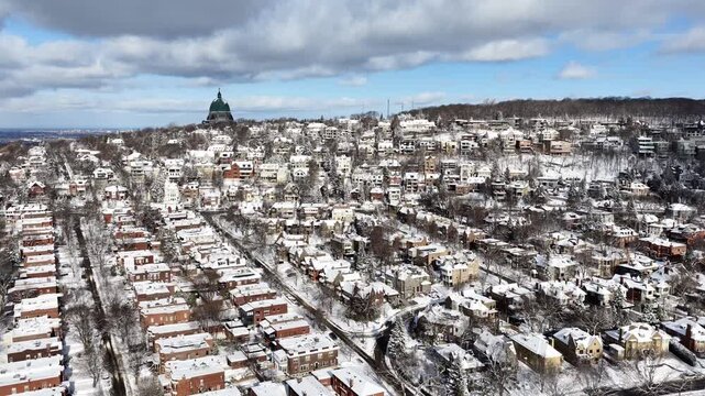 Saint Josephs Oratory dome above snowy Westmount and Montreal neighborhood on Mount Royal hill in winter, Quebec, Canada. g.