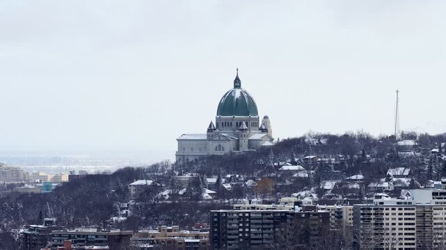 Saint Josephs Oratory dome above snowy Westmount and Montreal neighborhood on Mount Royal hill in winter, Quebec, Canada. g.