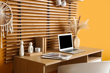 Fototapeta premium Workplace with laptop, books and magazines in stylish office