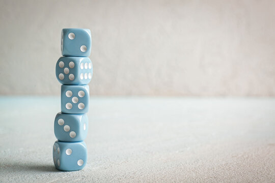 Stack of blue dices on light background