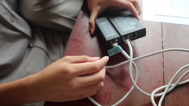 Testing a network cable with a LAN tester.