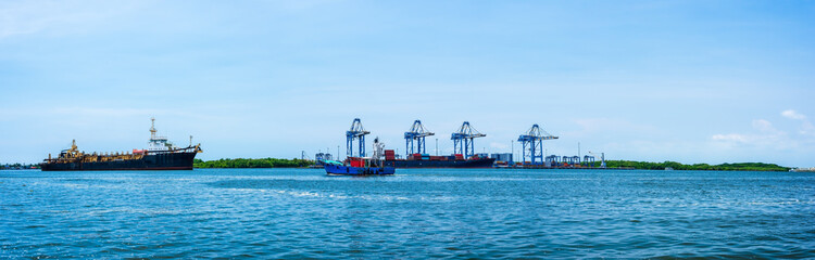 Fototapeta premium Panoramic sea view, cargo container ship and cityscapes of Kerala, India.