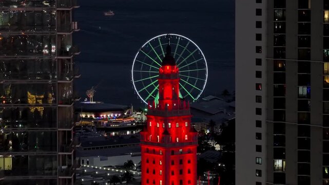 Miami cityscape, Freedom Tower and ferris wheel at night time.