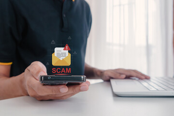 A man receives a malicious or scam message on his smartphone. Phishing, scam, or spam alert. © fadfebrian