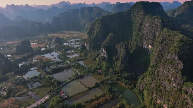 Aerial view of the stunning Tam Coc rice fields and limestone karst landscape in Ninh Binh, Vietnam. A popular tourist destination for its natural beauty.