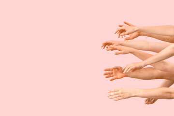 Naklejka premium Many hands on pink background