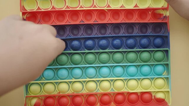 Learning to pop a fidget toy for fun and stress relief