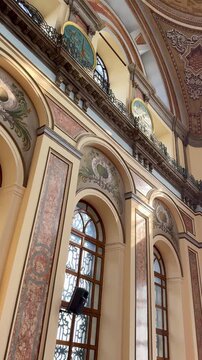 Ornate interior of Dolmabahce Mosque in Istanbul, Turkey. Features of Ottoman Baroque architecture with marble columns and arched windows. Historic Bezmialem Valide Sultan Mosque.