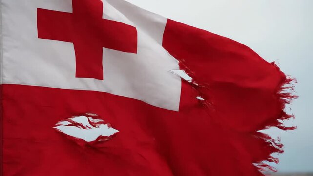 Tattered Tonga Flag with Torn Fabric Waving in Strong Winds