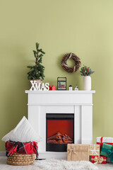 Naklejka premium Interior of living room with fireplace, Christmas decor and presents
