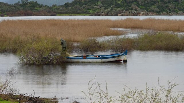 Traditional Wooden Fishing Boat Moored in the Reeds of Bafa Lake, Turkey. High quality 4k footage