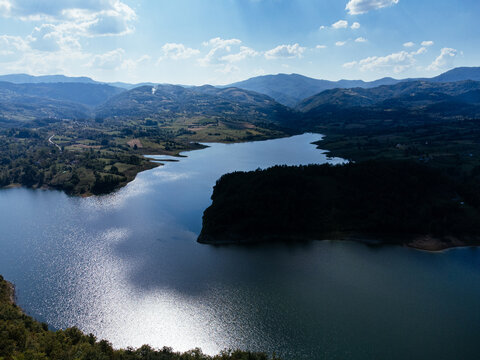 Aerial view of Rovni Lake reservoir and surrounding hilly landscape in Serbia. g.