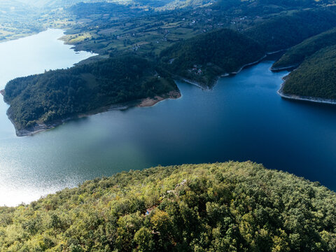 Aerial view of Rovni Lake reservoir and surrounding hilly landscape in Serbia. g.